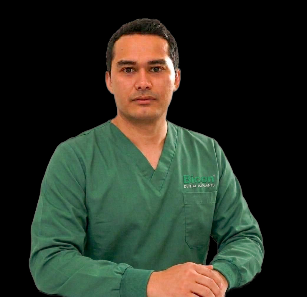 Guzman Jaime Guzman, oral surgeon, faculty member in green scrubs
